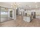 Bright kitchen features white cabinets, stainless appliances, mosaic backsplash and a large center island at 1272 Patterson Ter, Lake Mary, FL 32746