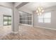 Open-concept living area with tile floors, a modern chandelier, and a view of the outdoor pool at 1272 Patterson Ter, Lake Mary, FL 32746