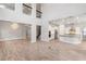 Open-concept living room with a two-story ceiling, tile flooring, and a modern kitchen at 1272 Patterson Ter, Lake Mary, FL 32746