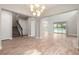 Expansive living space with staircase, tile flooring, and sliding glass doors to the pool area at 1272 Patterson Ter, Lake Mary, FL 32746