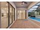 This covered patio offers views of the pool, outdoor space, and access to the interior of the home at 1272 Patterson Ter, Lake Mary, FL 32746