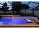 Inviting screened-in pool area with a relaxing spa illuminated with a blue glow at 1272 Patterson Ter, Lake Mary, FL 32746