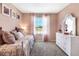 Charming bedroom with pink walls, bright windows, a white dresser, and carpet flooring at 1304 Isleta Loop, Kissimmee, FL 34741