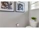 Half bath featuring framed art and a toilet with a decorative plant at 1310 Isleta Loop, Kissimmee, FL 34741