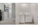 Laundry room with modern washer and dryer next to hallway with carpet at 1310 Isleta Loop, Kissimmee, FL 34741