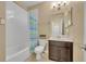 Bathroom with tile floors, tub with shower, and a vanity with ample storage space at 1356 Coralstone Dr, Celebration, FL 34747