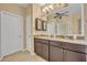 Spacious bathroom featuring double sinks, granite counters, and plenty of cabinet storage at 1356 Coralstone Dr, Celebration, FL 34747