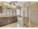 Bright primary bathroom with walk-in shower, soaking tub, granite countertops, and double sinks at 1356 Coralstone Dr, Celebration, FL 34747