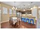 Charming dining area adjacent to kitchen with natural light and modern chandelier at 1356 Coralstone Dr, Celebration, FL 34747