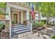 Inviting front porch with stone accents, classic columns, a stylish front door, and manicured landscaping at 1356 Coralstone Dr, Celebration, FL 34747