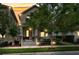 Charming two-story home at twilight featuring a covered front porch with classic columns and a well-manicured front yard at 1356 Coralstone Dr, Celebration, FL 34747