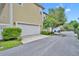 A large garage door with green bushes in front and a driveway at 1356 Coralstone Dr, Celebration, FL 34747