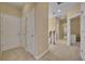 Bright hallway with carpet, white doors, and natural light from a nearby window at 1356 Coralstone Dr, Celebration, FL 34747