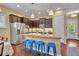 Open kitchen with stainless appliances, dark cabinets, and an island breakfast bar at 1356 Coralstone Dr, Celebration, FL 34747