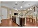 Spacious open kitchen featuring a large center island with breakfast bar, hardwood floors and stainless appliances at 1356 Coralstone Dr, Celebration, FL 34747