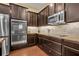 Gourmet kitchen with stainless steel appliances, granite countertops and rich cabinetry at 1356 Coralstone Dr, Celebration, FL 34747