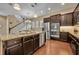 Spacious kitchen features a large island, stainless steel appliances and wooden floors at 1356 Coralstone Dr, Celebration, FL 34747