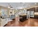 Open concept kitchen with hardwood floors, stainless appliances, island, and view into the living room and staircase at 1356 Coralstone Dr, Celebration, FL 34747