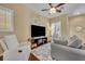 Comfortable living room features a ceiling fan, natural light and neutral tones at 1356 Coralstone Dr, Celebration, FL 34747