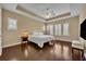 Main bedroom with hardwood floors, tray ceiling, plantation shutters, and neutral paint at 1356 Coralstone Dr, Celebration, FL 34747