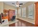Comfortable home office featuring hardwood floors, plantation shutters, and a built-in bookcase at 1356 Coralstone Dr, Celebration, FL 34747