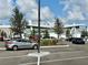 Daytime view of a grocery store exterior and parking lot under a partly cloudy sky at 1356 Coralstone Dr, Celebration, FL 34747