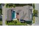 Aerial view showcases a private pool and a detached garage surrounded by lush landscaping at 13661 Granger Ave, Orlando, FL 32827