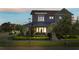 Charming two-story home boasts manicured landscaping, a metal roof and a welcoming front porch at 13661 Granger Ave, Orlando, FL 32827