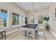 Spacious game room with a pool table and large windows overlooking the neighborhood at 13661 Granger Ave, Orlando, FL 32827