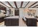 Large kitchen with dark cabinets, granite countertops, kitchen island with seating, and stainless appliances at 13661 Granger Ave, Orlando, FL 32827