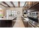Modern kitchen featuring dark wood cabinets, granite countertops, stainless steel appliances, and an island at 13661 Granger Ave, Orlando, FL 32827