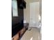 Mud room featuring a bench with baskets and a shelf with hooks, adjacent to a white door at 13661 Granger Ave, Orlando, FL 32827