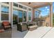 Covered outdoor living space featuring a built-in kitchen, dining area, and comfortable seating at 13661 Granger Ave, Orlando, FL 32827