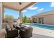 Outdoor living space with a fully-equipped kitchen, dining table, and a view of the pool and backyard at 13661 Granger Ave, Orlando, FL 32827