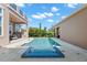 Inviting backyard pool and spa featuring blue tile, a spacious patio, and an outdoor kitchen area at 13661 Granger Ave, Orlando, FL 32827
