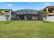 Large backyard featuring a screened-in patio and plenty of space for activities at 14072 Alafaya Oak Bnd, Orlando, FL 32828