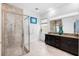 Elegant bathroom featuring a glass-enclosed shower and dual vanity with granite countertops at 14072 Alafaya Oak Bnd, Orlando, FL 32828