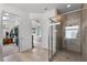 Beautiful primary bathroom features a large glass shower, tile flooring, and a walk-in closet with entry to the main bedroom at 14072 Alafaya Oak Bnd, Orlando, FL 32828