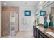 Stylish bathroom with a tiled glass shower, dual sink vanity, and modern fixtures at 14072 Alafaya Oak Bnd, Orlando, FL 32828