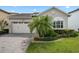 Charming home featuring a two-car garage, paver driveway, complemented by a well-manicured lawn and tasteful landscaping at 14072 Alafaya Oak Bnd, Orlando, FL 32828
