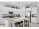 Bright, modern kitchen features a granite island with seating, stainless steel appliances, and ample cabinet space at 14072 Alafaya Oak Bnd, Orlando, FL 32828