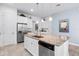 Kitchen featuring a large island with granite countertops and sink, stainless steel appliances, and sleek cabinetry at 14072 Alafaya Oak Bnd, Orlando, FL 32828