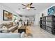 Open living area featuring tile flooring, neutral decor, seamlessly connecting to the kitchen and dining at 14072 Alafaya Oak Bnd, Orlando, FL 32828