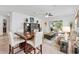 Open living and dining area featuring tile floors, modern furnishings, and natural light from sliding glass doors at 14072 Alafaya Oak Bnd, Orlando, FL 32828