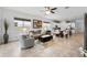 Open-concept living room and kitchen with tile floors, large windows, and modern appliances at 14072 Alafaya Oak Bnd, Orlando, FL 32828
