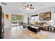 Bright living room with neutral tones, ceiling fan, and sliding glass doors to the outdoor patio at 14072 Alafaya Oak Bnd, Orlando, FL 32828