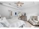 Neutral tones and tray ceilings highlight this bedroom featuring ample space and natural light at 14072 Alafaya Oak Bnd, Orlando, FL 32828