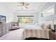 Serene main bedroom with tray ceiling, plush carpeting, and a relaxing sitting area at 14072 Alafaya Oak Bnd, Orlando, FL 32828