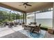 Spacious screened patio with outdoor dining set and ceiling fan, perfect for enjoying outdoor meals and gatherings at 14072 Alafaya Oak Bnd, Orlando, FL 32828