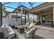 Inviting screened patio with comfortable seating, a gas fire pit, offering a relaxed outdoor living space at 14072 Alafaya Oak Bnd, Orlando, FL 32828